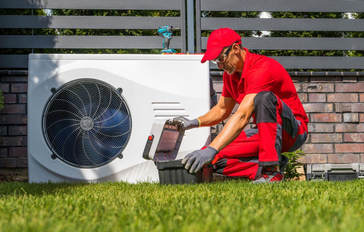 Techniker arbeitet an der Installation einer modernen Wärmepumpe im Garten – ideal für energieeffizientes und nachhaltiges Heizen. Passend für wärmepumpe kaufen leipzig.